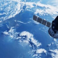 shutterstock 2291065933 space satellite in orbit above the Earth white clouds and blue sea below