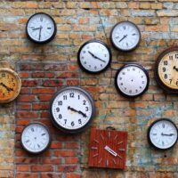 shutterstock 435558448 old clocks on brick wall time, time change, timeless