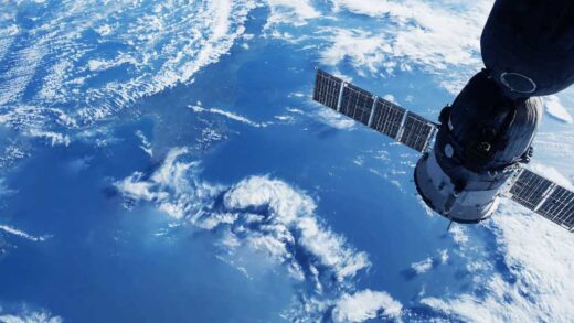 shutterstock 2291065933 space satellite in orbit above the Earth white clouds and blue sea below