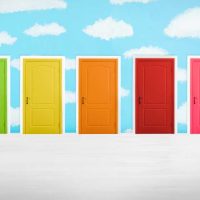 Many colorful doors in a room. Concept of choice. Green, yellow, orange, red, and pink doors on a brushed silver foreground and painted bright blue and white cloud background.