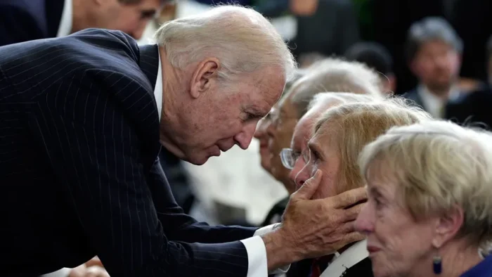 Joe biden comforting elderly woman