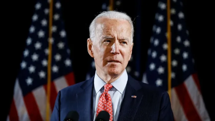 Joe biden speaking podium american flags