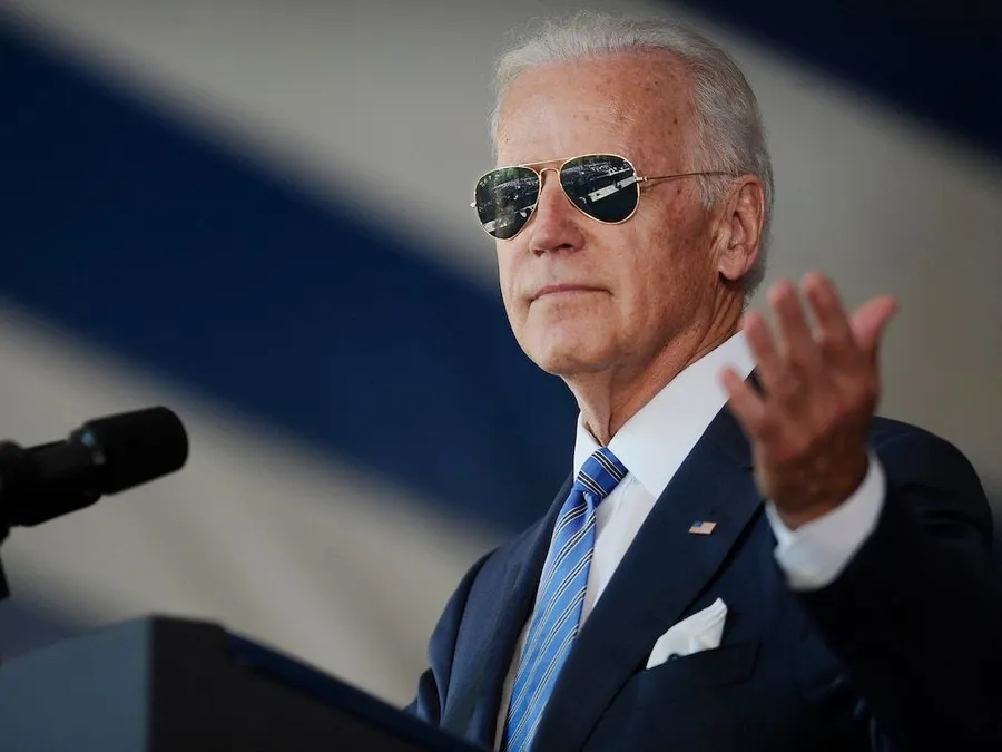 Joe biden speaking with sunglasses podium