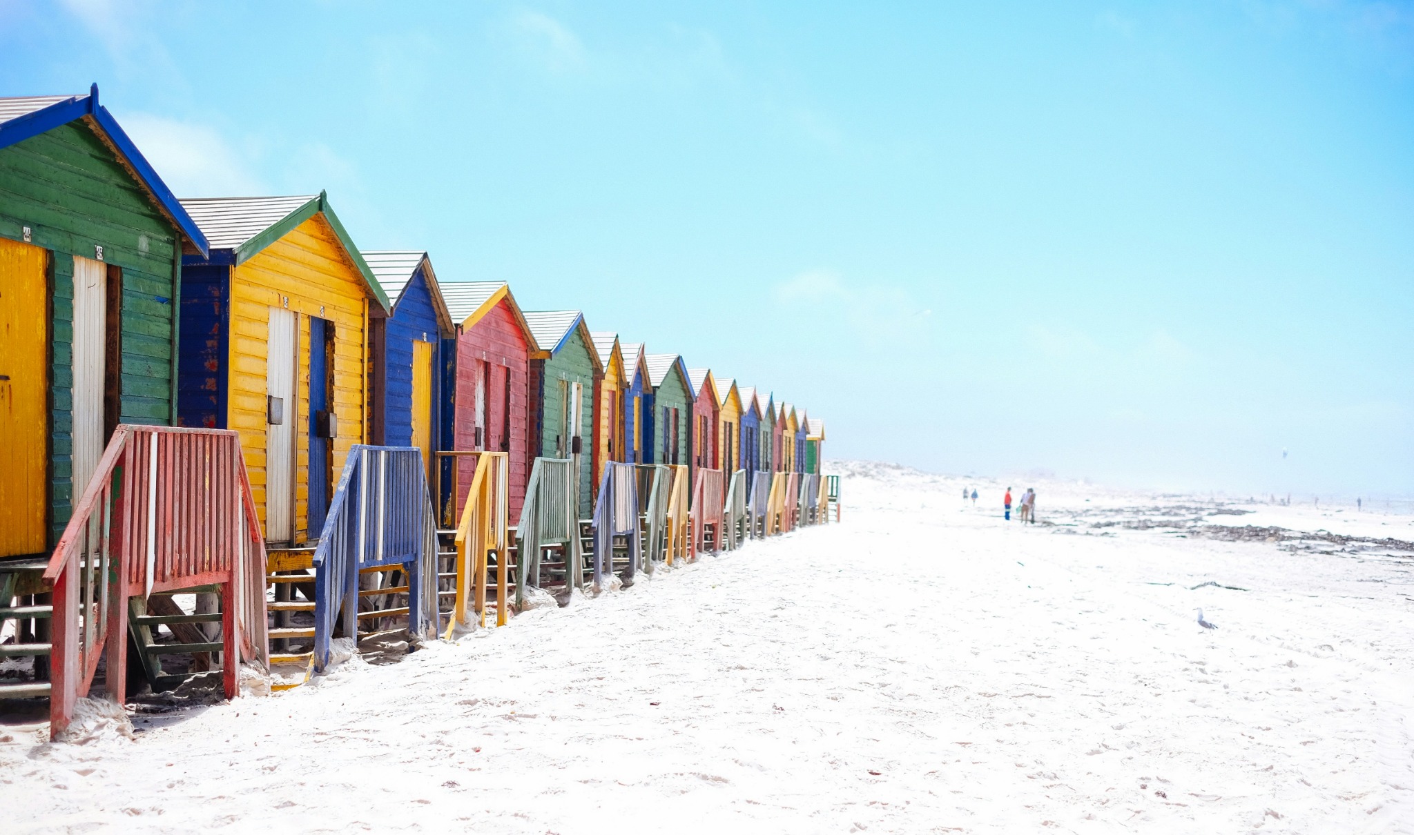 Colorful beach huts sandy shore