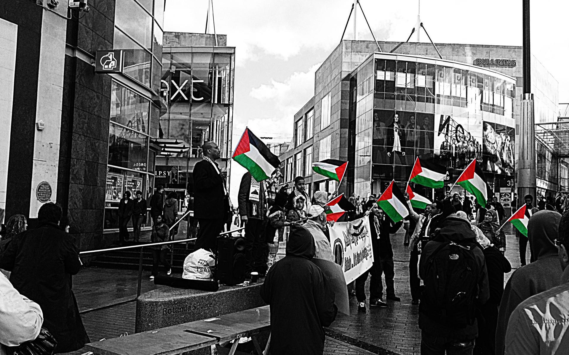 Palestinian flag protest in urban setting wallpaper