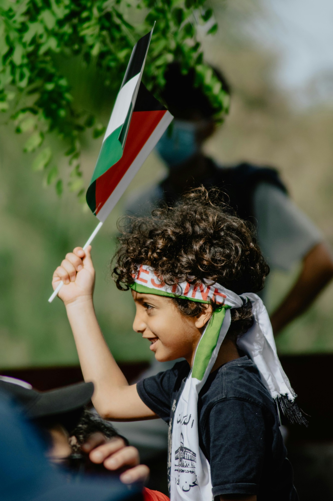 Young boy holding palestinian flag wallpaper