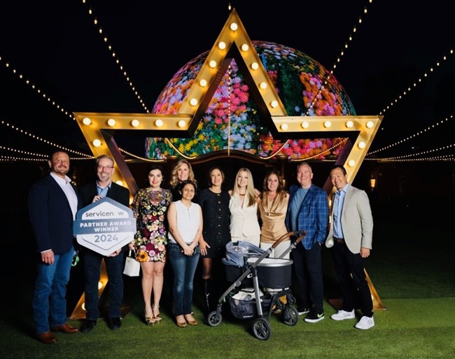 a group of people posing for a photo in front of a carnival ride