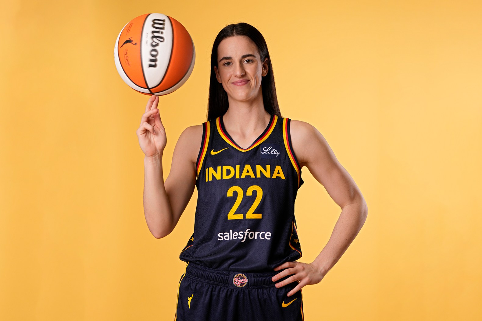 Caitlin clark spinning basketball yellow background wallpaper