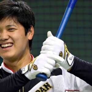 Shohei ohtani smiling with bat