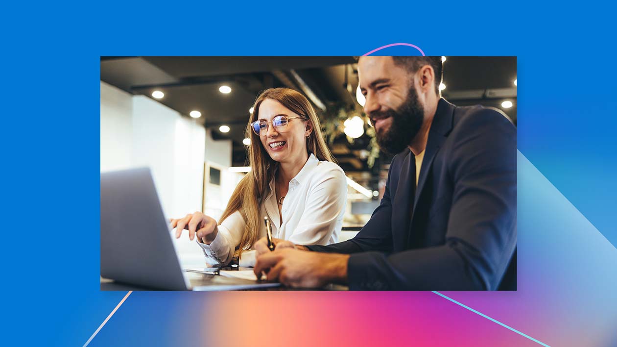 A man and woman looking at a laptop