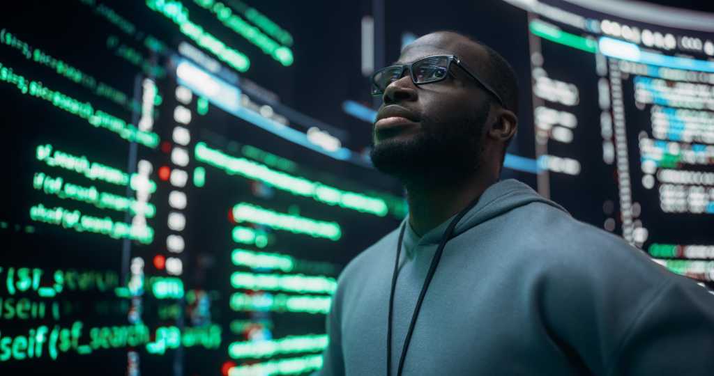 Portrait of Worried Professional Programmer Fixing a Bug, Dealing with Crashing System. Young Black Man Looking at Big Digital Screens Glitching While Displaying Code Lines, Thinking of Solutions