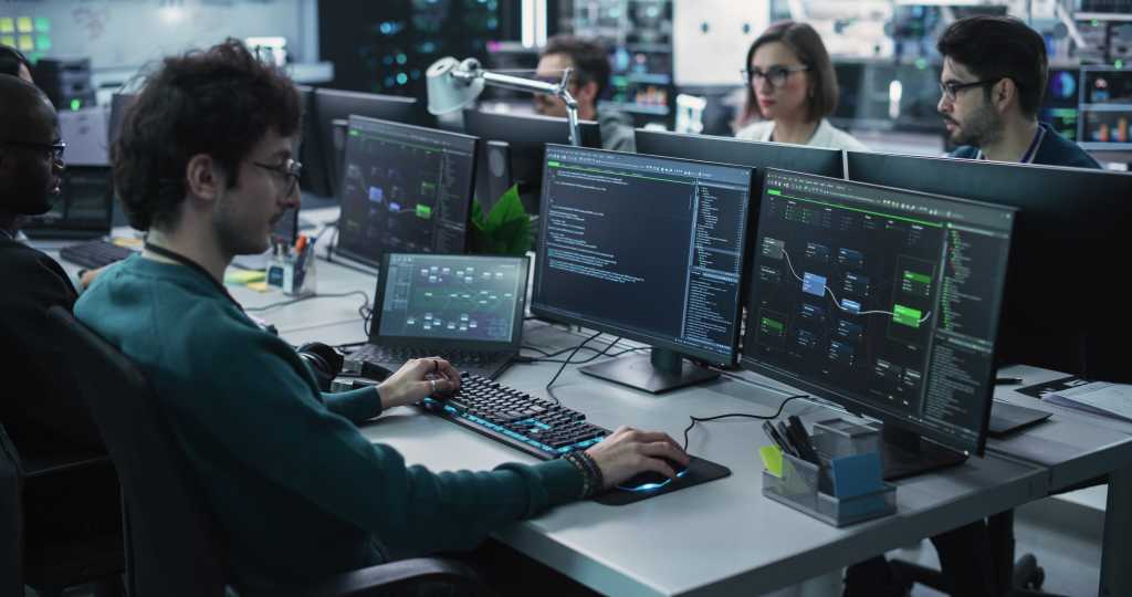 Team of Diverse Multiethnic Software Developers Working on Computers, Programming Advanced Code, Managing Artificial Intelligence Projects Online for Innovative Cybersecurity Technology Company